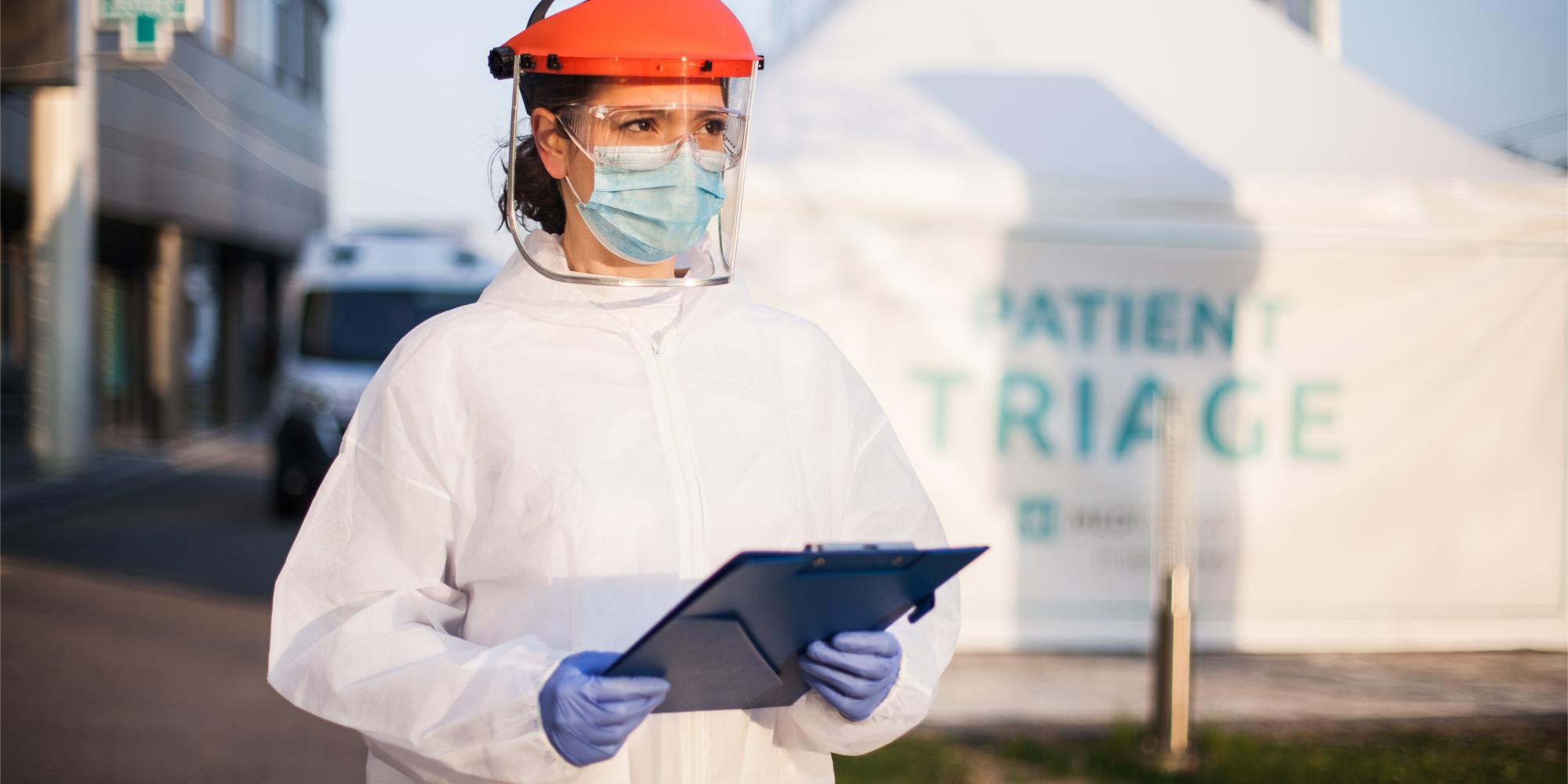 Woman wearing PPE outside of COVID-19 testing facility