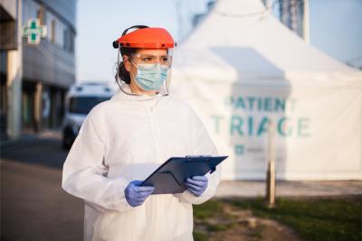 Woman wearing PPE outside of COVID-19 testing facility