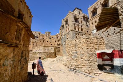 Woman walking through Yemeni village